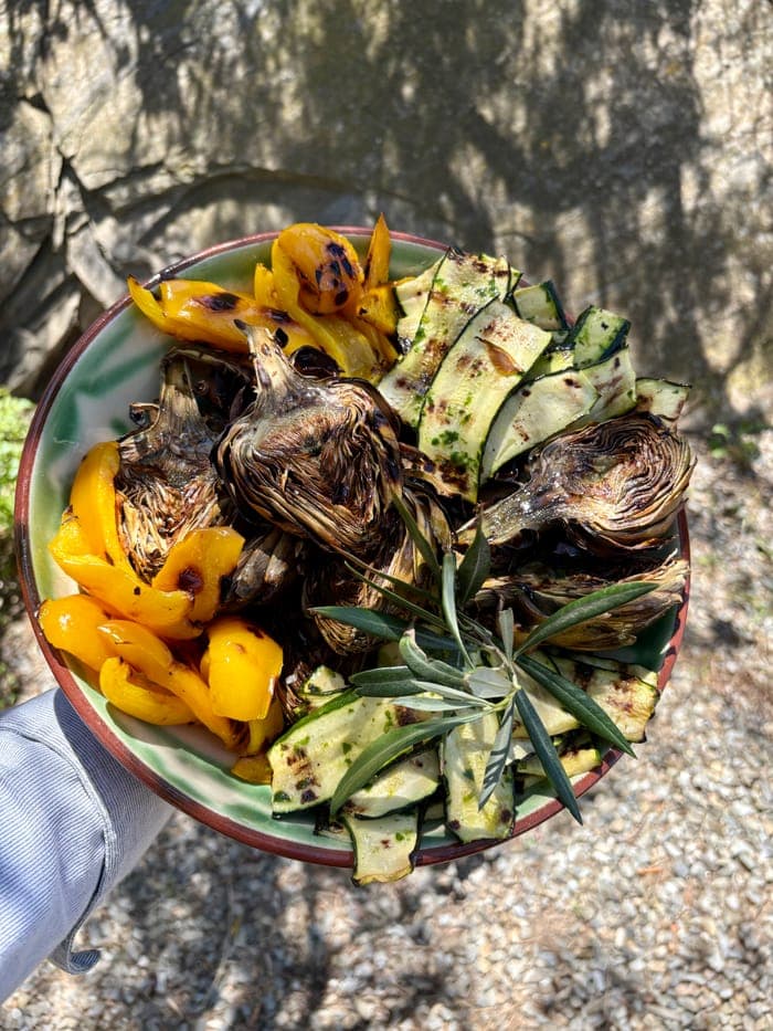 A bowl of grilled artichokes, peppers and courgettes
