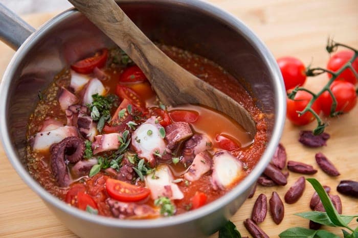 Octopus and cherry tomato stew simmering in a pot
