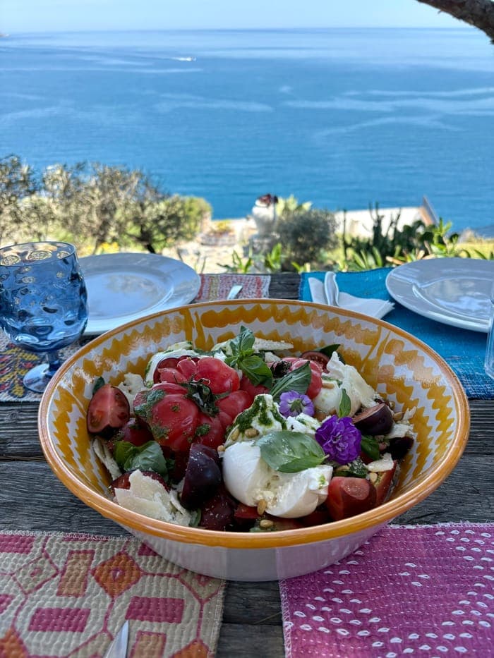 Burrata and tomato salad served with a Mediterranean sea view