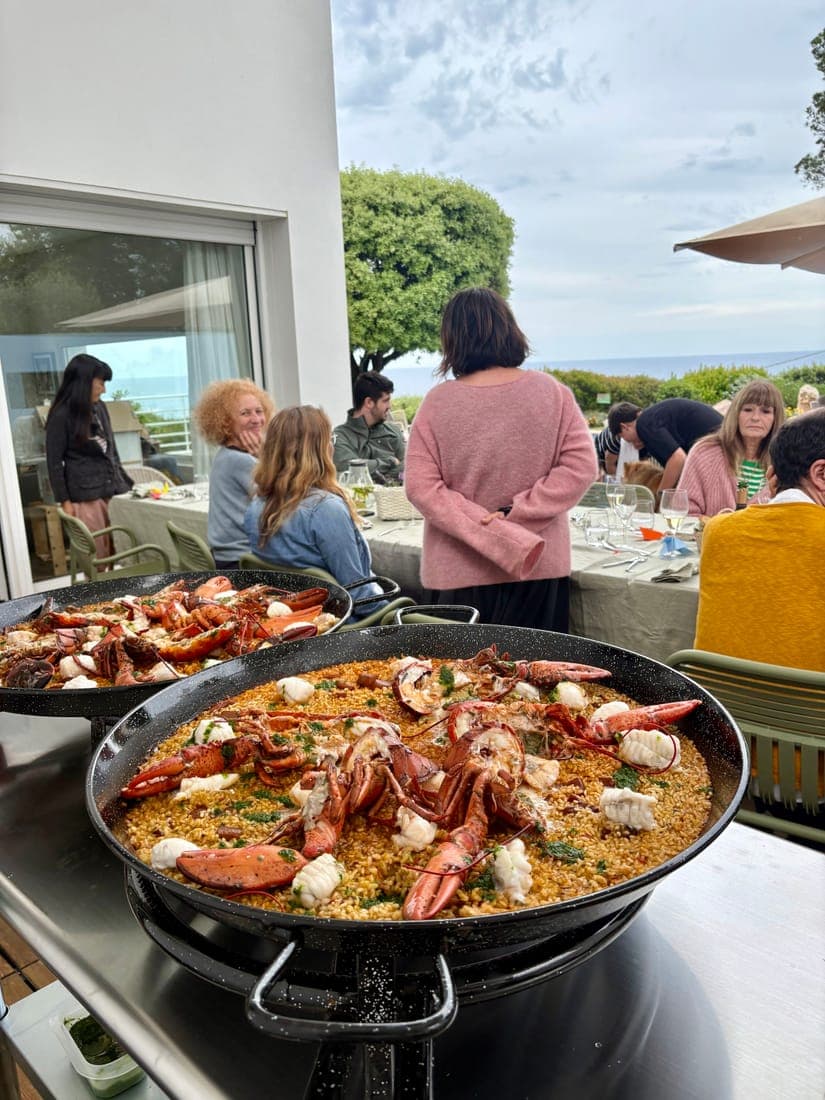 Lobster paella served on a villa terrace overlooking the sea