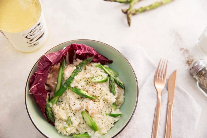 Prawn and asparagus risotto in a radicchio-lined bowl